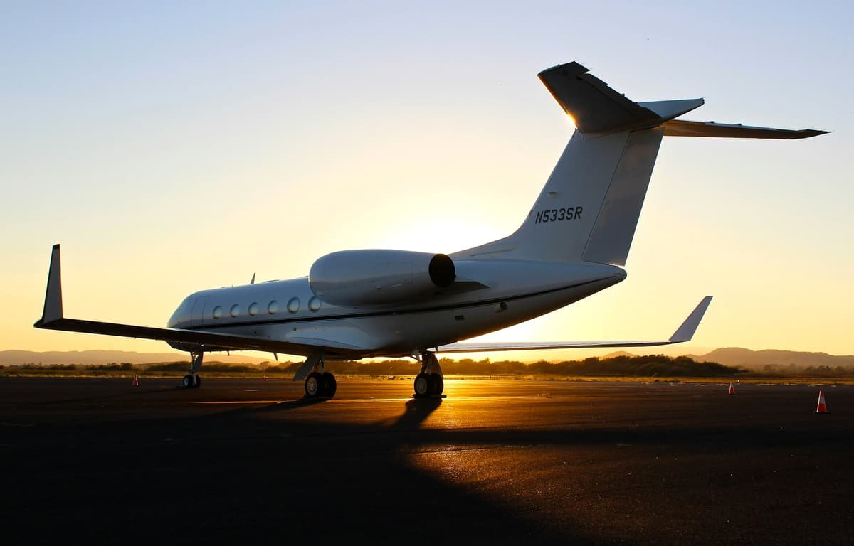 A private jet on the apron at sunset